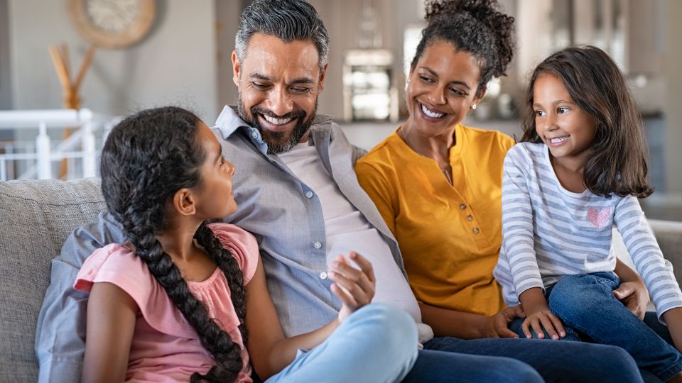 smiling-family-on-couch